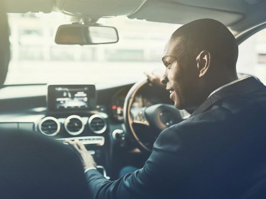 Professional chauffeur driving a client through Dubai in a premium sedan