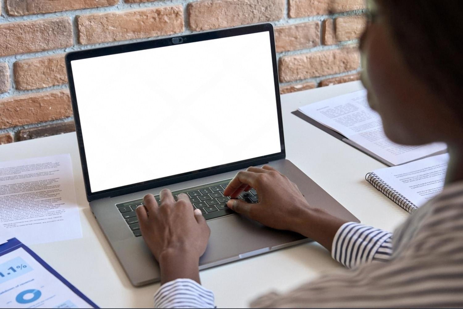 Employee working on a laptop with licensed business software in a UAE office